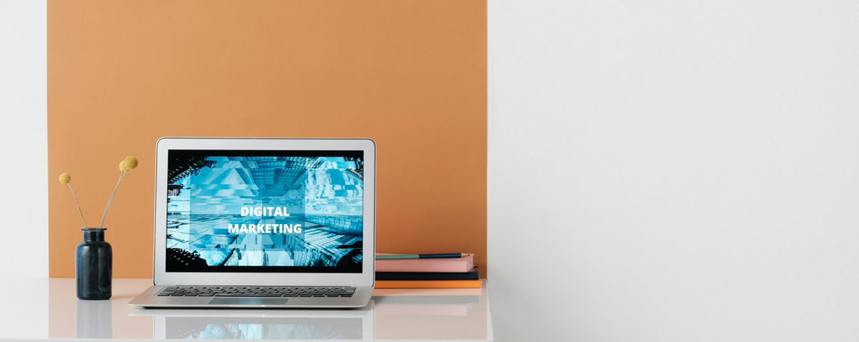 A clean, modern workspace featuring a laptop with digital marketing on screen, ideal for business use.